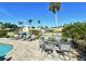 Outdoor patio area with lounge chairs, patio seating, and a lush tropical landscaping, perfect for relaxing and entertaining guests at 537 Gunwale Ln, Longboat Key, FL 34228