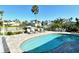 Sparkling pool surrounded by lounge chairs and lush landscaping with a canal view in the background at 537 Gunwale Ln, Longboat Key, FL 34228
