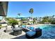 Backyard oasis with outdoor seating area and sparkling pool surrounded by lush tropical landscaping at 537 Gunwale Ln, Longboat Key, FL 34228