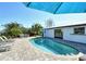 Inviting backyard pool area with lounge chairs, patio seating, and a lush tropical landscaping, perfect for relaxing or entertaining at 537 Gunwale Ln, Longboat Key, FL 34228