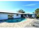 Backyard pool area with lounge chairs and patio seating, surrounded by a lush tropical landscaping, creating a relaxing outdoor space at 537 Gunwale Ln, Longboat Key, FL 34228