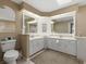 Bathroom featuring dual sinks, lots of cabinets, and an area for accessories at 555 Park Estates Sq, Venice, FL 34293
