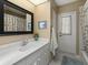 Bathroom featuring single sink vanity with an framed mirror and white cabinets at 555 Park Estates Sq, Venice, FL 34293