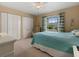 Bedroom with a large window, lots of closet space, and carpeted floors at 555 Park Estates Sq, Venice, FL 34293
