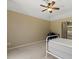 Bright bedroom with large windows, ceiling fan, and attached bathroom at 555 Park Estates Sq, Venice, FL 34293