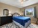 Bedroom with a dark wood dresser, a bed with blue bedding, and wood floors at 555 Park Estates Sq, Venice, FL 34293