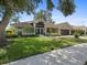 Charming single-story home with manicured lawn, lush landscaping, and a spacious two-car garage at 555 Park Estates Sq, Venice, FL 34293