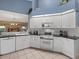 Bright kitchen boasts white cabinets, granite countertops, and stainless appliances, with an open layout at 555 Park Estates Sq, Venice, FL 34293