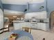 Well-lit kitchen with white cabinetry and stainless steel appliances flows into the adjacent dining and living areas at 555 Park Estates Sq, Venice, FL 34293