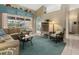 Cozy living room featuring tile floors, comfortable furnishings, and view of the outdoor patio and pool at 555 Park Estates Sq, Venice, FL 34293