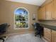 Bright office space with built-in desk, lots of storage, and large arched window at 555 Park Estates Sq, Venice, FL 34293