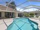 Beautiful screened-in pool area with a patio and comfortable lounge chairs at 555 Park Estates Sq, Venice, FL 34293