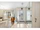 Inviting foyer with tile floors, mirrored wall, and view to living area at 5704 Whistlewood Cir, Sarasota, FL 34232