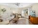 Cozy living room with ceiling fan and sliding door to patio at 5704 Whistlewood Cir, Sarasota, FL 34232