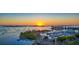 Stunning aerial view captures the marina and waterfront, lit by the sun setting over the city skyline at 600 Mourning Dove Dr, Sarasota, FL 34236