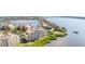 An aerial view showcases this waterfront condo's location near the marina and the Intracoastal at 615 Riviera Dunes Way # 208, Palmetto, FL 34221