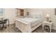 Bright bedroom featuring a charming white bed frame, a window with blinds, and a stylish desk area at 615 Riviera Dunes Way # 208, Palmetto, FL 34221