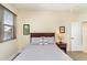 Cozy bedroom featuring a neutral color palette, a window with blinds, and a comfortable bed with decorative pillows at 615 Riviera Dunes Way # 208, Palmetto, FL 34221