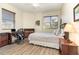 Bedroom featuring a wood floor, ceiling fan, desk and large bed at 615 Riviera Dunes Way # 208, Palmetto, FL 34221