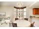 Bright dining area with a chandelier and a bay window overlooking the building's exterior at 615 Riviera Dunes Way # 208, Palmetto, FL 34221