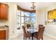 Corner dining area with a bay window offering views of palm trees at 615 Riviera Dunes Way # 208, Palmetto, FL 34221