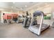 Well-equipped gym with treadmills, ellipticals, free weights, and a mirrored wall, for a complete workout experience at 615 Riviera Dunes Way # 208, Palmetto, FL 34221