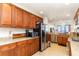 Bright kitchen features granite counters, stainless steel appliances, and abundant wooden cabinetry at 615 Riviera Dunes Way # 208, Palmetto, FL 34221