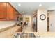 Bright kitchen features granite counters, stainless steel appliances, and abundant wooden cabinetry at 615 Riviera Dunes Way # 208, Palmetto, FL 34221