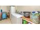 Bright laundry room with modern washer and dryer, storage cabinets, and folding area for added convenience at 615 Riviera Dunes Way # 208, Palmetto, FL 34221