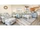Comfortable living room featuring stylish furniture, a patterned rug, and bright natural light at 615 Riviera Dunes Way # 208, Palmetto, FL 34221