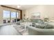 Bright and airy living room with a balcony, light wood floors and tasteful coastal decor at 615 Riviera Dunes Way # 208, Palmetto, FL 34221