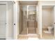 Walk-in shower with glass door and tile surround at 615 Riviera Dunes Way # 208, Palmetto, FL 34221