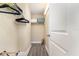 Functional walk-in closet with ample storage space, including shelving and hanging racks, and neutral walls at 615 Riviera Dunes Way # 208, Palmetto, FL 34221