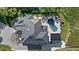 Aerial view of the property showcasing the pool, outdoor living spaces, and lush landscaping at 6178 9Th Avenue Ne Cir, Bradenton, FL 34212