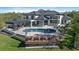 Backyard featuring an outdoor kitchen, an open patio, and a luxurious pool surrounded by an elegant patio at 6178 9Th Avenue Ne Cir, Bradenton, FL 34212