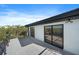 Outdoor balcony featuring tile flooring, modern lighting, and a scenic nature view at 6178 9Th Avenue Ne Cir, Bradenton, FL 34212