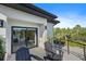 Modern balcony features tile flooring, black railing, and outdoor seating with lush greenery views at 6178 9Th Avenue Ne Cir, Bradenton, FL 34212