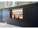 Sophisticated bar area with custom dark cabinetry, open shelving, and curated collection of spirits at 6178 9Th Avenue Ne Cir, Bradenton, FL 34212