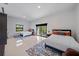 Bright bedroom with two beds, a sliding glass door to a balcony, and modern decor at 6178 9Th Avenue Ne Cir, Bradenton, FL 34212