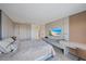 Bright bedroom offers a dedicated desk and an entertainment center with mounted tv at 6178 9Th Avenue Ne Cir, Bradenton, FL 34212