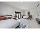 Bright bedroom with two beds, tile floor, large windows, and access to the patio with outdoor furniture at 6178 9Th Avenue Ne Cir, Bradenton, FL 34212