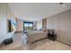 Bright bedroom featuring a balcony with beautiful views, light walls, and modern furnishings at 6178 9Th Avenue Ne Cir, Bradenton, FL 34212