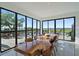 Dining room with modern table and floor-to-ceiling windows offering stunning water views at 6178 9Th Avenue Ne Cir, Bradenton, FL 34212