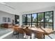 Bright dining room features unique table and windows with views of the landscaped outdoors at 6178 9Th Avenue Ne Cir, Bradenton, FL 34212