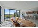 Dining room features custom wood table, wall of windows, and open access to the kitchen at 6178 9Th Avenue Ne Cir, Bradenton, FL 34212