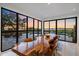 Dining room featuring unique wood table and floor-to-ceiling windows with sunset views at 6178 9Th Avenue Ne Cir, Bradenton, FL 34212