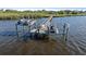Private dock with boat and jet ski lifts offering direct access to the water at 6178 9Th Avenue Ne Cir, Bradenton, FL 34212
