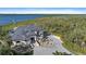 An elegant waterfront estate featuring a circular driveway, meticulous landscaping, and an attached private dock at 6178 9Th Avenue Ne Cir, Bradenton, FL 34212