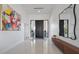 A modern foyer featuring high ceilings, white tile flooring, and a contemporary design with natural lighting at 6178 9Th Avenue Ne Cir, Bradenton, FL 34212