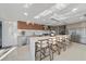 Modern kitchen features a waterfall island with seating and stainless steel appliances at 6178 9Th Avenue Ne Cir, Bradenton, FL 34212